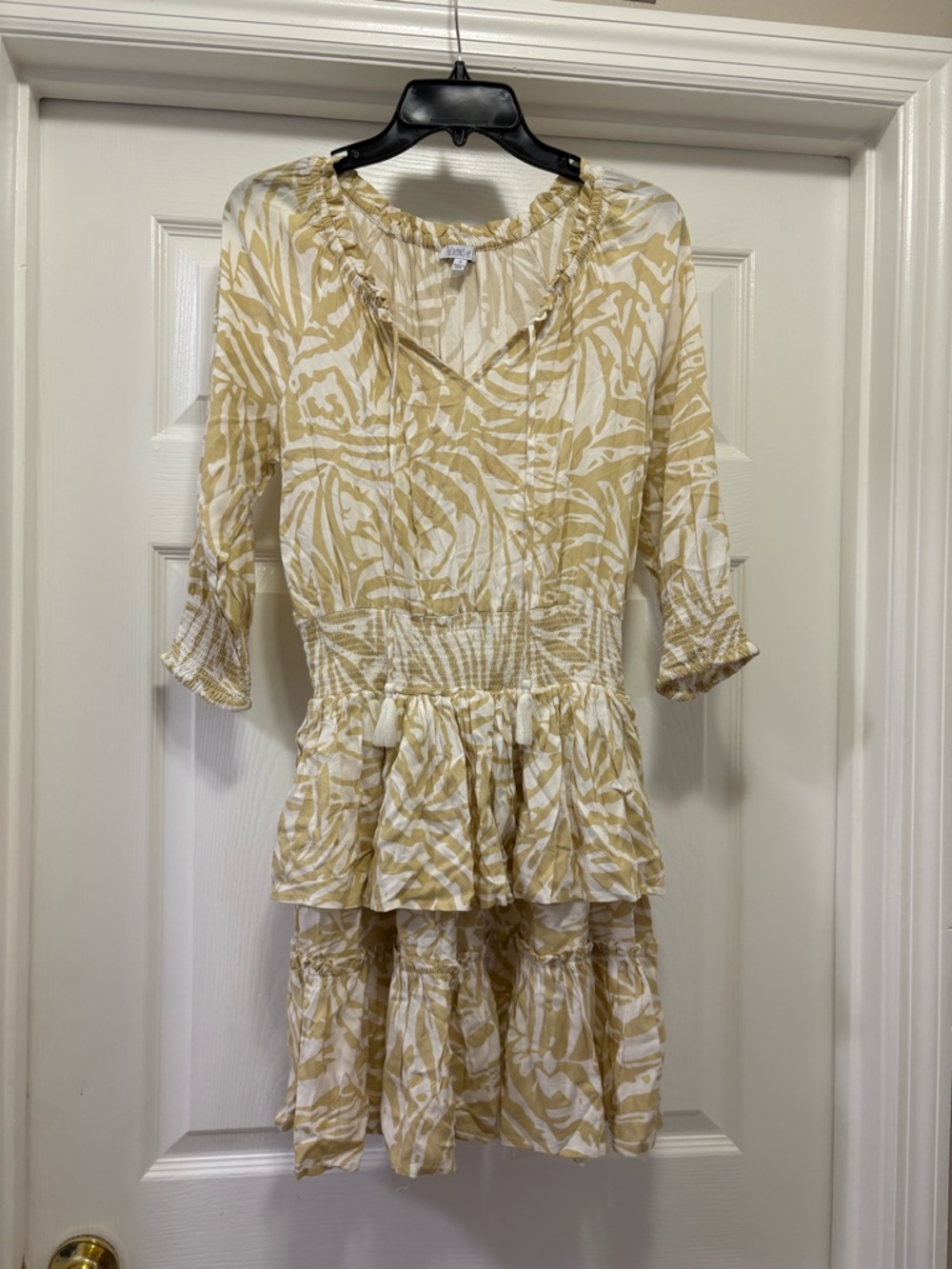 Patrons of Peace tiered mini dress featuring a tan and white palm leaf print